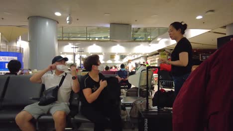 Static-shot-of-Chinese-people-at-Beijing-Capital-airport-terminal-waiting-area-during-Covid-19-pandemic