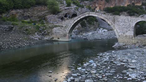 Medieval-bridge-over-a-sulfur-rich-river-leads-to-a-natural-spa-in-Albania