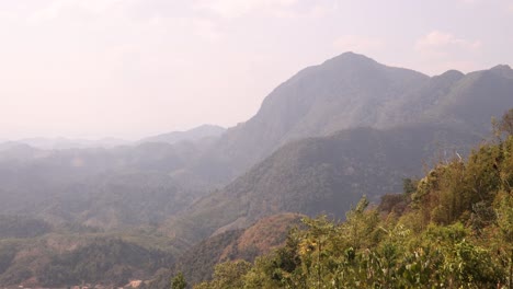 drone-shot-floating-over-the-saddle-of-a-hike-in-the-mountain-town-of-Nong-Khiaw-in-Laos,-Southeast-Asia