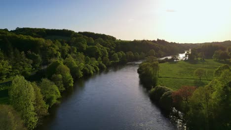 Vienne-river-crossing-Saint-Victurnien-verdant-countryside-at-sunset,-Nouvelle-Aquitaine-in-France