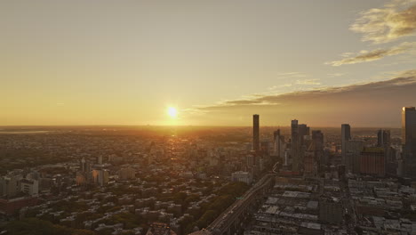 NYC-New-York-Aerial-v369-flyover-East-river-and-Queensboro-Bridge-capturing-cityscape-of-Long-Island-City-in-Queens-and-glowing-sun-rising-on-the-horizon---Shot-with-Mavic-3-Pro-Cine---September-2023