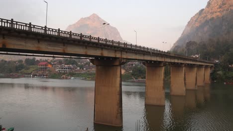 bridge-spanning-the-river-in-the-mountain-town-of-Nong-Khiaw-in-Laos,-Southeast-Asia