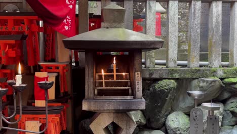 Candles-lit-in-a-shrine-in-Fushimi-Inari-Taisha-in-Kyoto-Japan