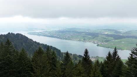 Aerial-revealing-of-Meggen-and-Luzern-town-at-Vierwaldstättersee-during-cloudy-day,-Switzerland