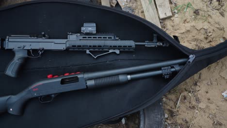 Shotgun-and-tactical-assault-rifle-in-black-open-bag,-Olesko-shooting-range