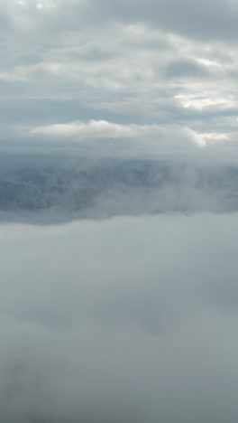 Vertical-4k-Timelapse,-Fast-Moving-Clouds-Above-Valley-and-Mountain-Peaks