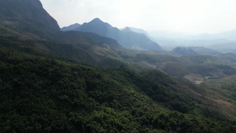 Disparo-De-Un-Dron-Flotando-Sobre-El-Bosque-En-Las-Montañas-En-La-Ciudad-Montañosa-De-Nong-Khiaw-En-Laos,-Sudeste-De-Asia