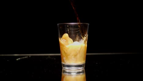 Cola-being-poured-into-a-clear-glass-foams-and-creates-bubbles