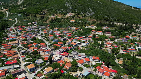 Beautiful-township-near-green-mountains-in-Zakynthos-island,-aerial-drone-view