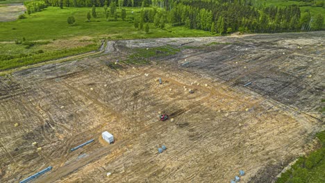 Preparing-a-countryside-field-to-install-solar-panels---aerial-parallax-hyper-lapse