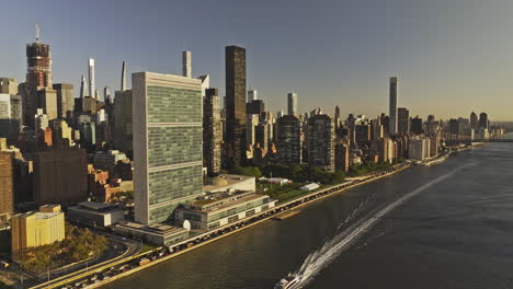 NYC-New-York-Aerial-v389-flyover-East-river-capturing-FDR-Dr-traffic,-Midtown-Manhattan-cityscape,-United-Nations-headquarter,-Roosevelt-Island-at-sunrise---Shot-with-Mavic-3-Pro-Cine---September-2023