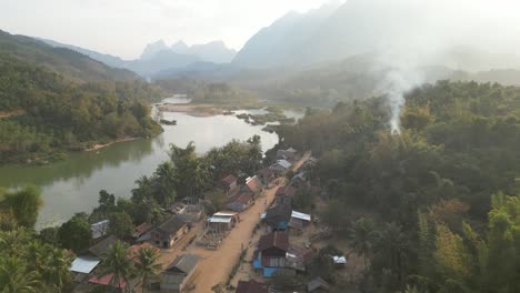 drone-shot-of-small-remote-village-in-the-mountain-town-of-Nong-Khiaw-in-Laos,-Southeast-Asia
