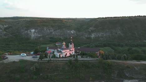 Fast-Truck-Right-Drone-Shot,-Archaeological-Reservation-Old-Orhei-with-Many-Calcareous-Slates,-Spacious-Caves-and-Small-Grottos,-with-Monastery-on-the-Top,-Moldova