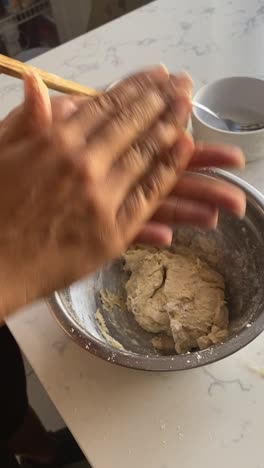 rolling-vegan-donut-batter-into-small-balls-and-adding-to-a-plate-to-air-fry