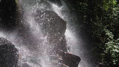 Backlit-Kanto-Lampo-waterfall-in-Bali-cascades-gracefully,-creating-a-scene-of-beauty-and-wonder