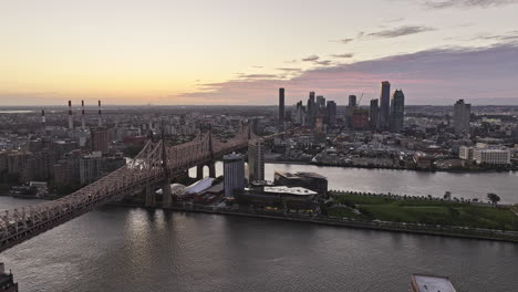 NYC-New-York-Aerial-v360-flyover-Midtown-Manhattan-capturing-Roosevelt-Island,-Queensboro-bridge-over-East-river,-sunrise-cityscape-of-Long-Island-City---Shot-with-Mavic-3-Pro-Cine---September-2023