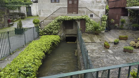 Tilt-up-along-fenced-canal-waterway-in-Portugal-in-quiet-neighborhood