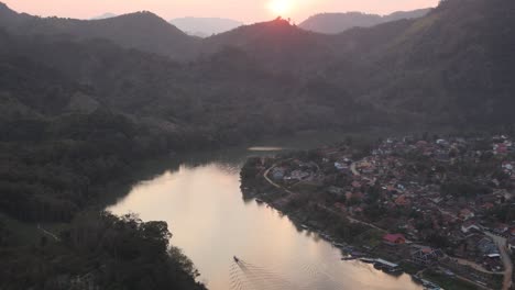 reflection-of-sunset-on-bend-in-river-in-the-mountain-town-of-Nong-Khiaw-in-Laos,-Southeast-Asia