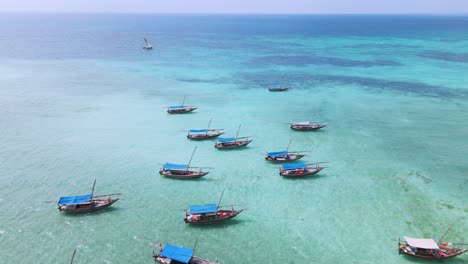 Boats-on-Reef-of-Kwale-Island-of-Zanzibar-in-the-Indian-Ocean,-Aerial