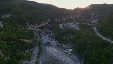 Beautiful-rocky-landscape-with-a-medieval-bridge-from-a-bird's-eye-view-at-sunset