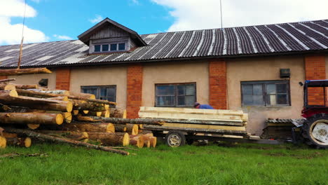 Local-farmers-preparing-timber-for-drying,-motion-view