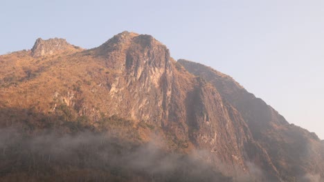 last-sun-light-of-the-day-glowing-on-the-mounatin-peaks-in-the-mountain-town-of-Nong-Khiaw-in-Laos,-Southeast-Asia