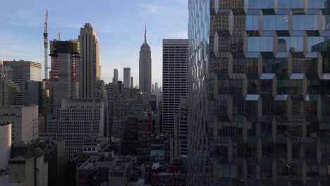 Aerial-view-flying-in-middle-of-buildings-in-Manhattan,-sunny-day-in-New-York