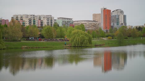 City-multistory-building-reflection-on-Nepomuk-Pond-at-Central-Park-Prague