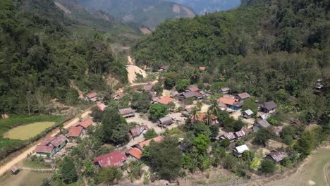drone-shot-of-remote-village-in-the-mountain-town-of-Nong-Khiaw-in-Laos,-Southeast-Asia