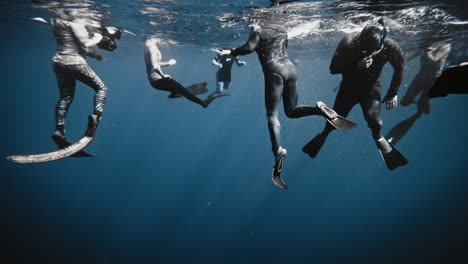 Underwater-photographers-and-snorklers-wait-at-surface-gathering-together