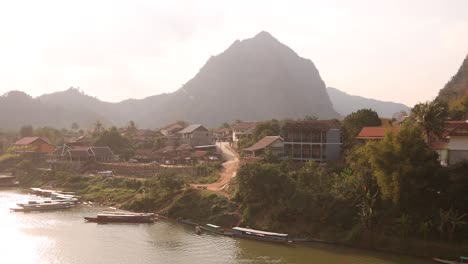 boats-docked-on-a-river-village-in-the-mountain-town-of-Nong-Khiaw-in-Laos,-Southeast-Asia