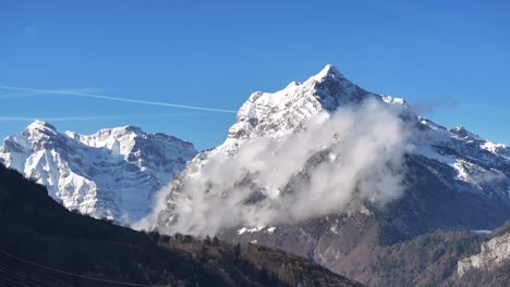 Snowy-Rautispitz-Mountain-With-Clouds-Against-Sunny-Blue-Sky-In-Canton-Of-Glarus,-Switzerland