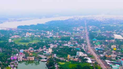 Panoramic-Aerial-View-Of-Growing-Urbanization-In-Barisal,-Bangladesh-Along-Kirtankhola-Riverbanks