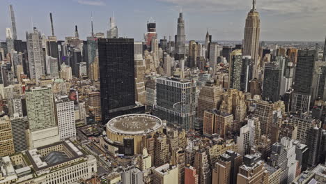 NYC-New-York-Aerial-v445-drone-flyover-Chelsea-capturing-Midtown-Manhattan-cityscape,-panning-down-birds-eye-view-of-famous-Madison-Square-Garden-Arena---Shot-with-Mavic-3-Pro-Cine---September-2023