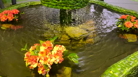 Flowers-floating-in-a-lake-with-a-fountain-and-waterfall-at-the-Festival-of-Flowers-in-the-Azores