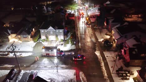Aerial-night-view-of-emergency-response-to-a-school-fire-in-snowy-Montréal,-Québec