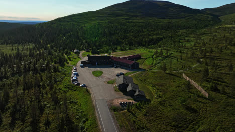 Aerial-view-circling-the-Lapland-hotel-Pallas,-sunny-summer-day-in-Finland