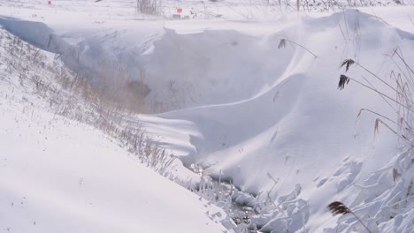 Stream-Flowing-In-Snow-Covered-Near-Countryside-In-Saint-Jean-sur-Richelieu,-Quebec-Canada