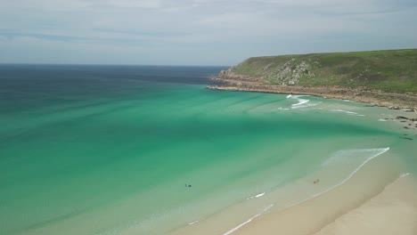 Gwenver-Beach-in-Cornwall-with-Crystal-Clear-Turquoise-Waters-Along-the-Cornish-Coastline,-Aerial-Drone-Panning-Shot,-UK