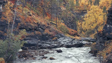 The-mountain-river-cascades-through-the-rocky-canyon-in-the-autumn-forest