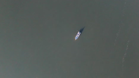 Descending-Aerial-Of-Fishermen-Fishing-From-Small-Boat