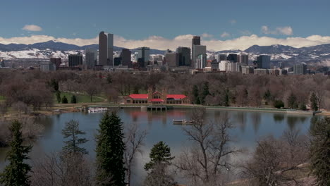 City-Park-calm-Ferril-Lake-Downtown-Denver-Colorado-aerial-drone-neighborhood-streets-Spring-Mount-Blue-Sky-Evans-Front-Range-Rocky-Mountains-foothills-skyscrapers-daytime-sunny-clouds-upward-slowly