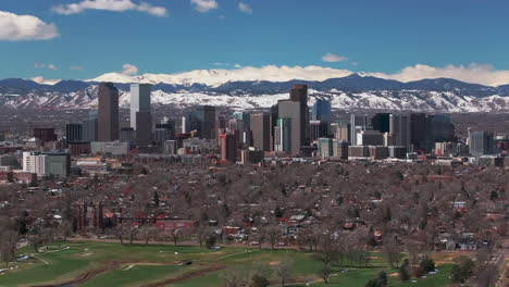 City-Park-Golf-Course-Downtown-Denver-Colorado-aerial-drone-neighborhood-streets-Spring-Mount-Blue-Sky-Evans-Front-Range-Rocky-Mountains-foothills-skyscrapers-Ferril-Lake-daytime-sunny-clouds-foward