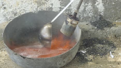 Metal-work-risky-with-lead,-use-lighter-to-burn-and-melt,-removing-impurities-using-ladle