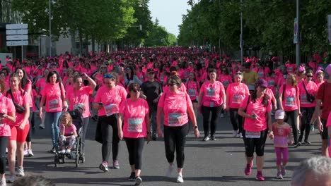 Pink-shirted-participants-flood-Madrid's-Women's-Race,-championing-awareness-for-metastatic-breast-cancer