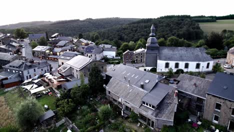 Pull-away-aerial-shot-of-Rochehaut-village-in-Belgium-Ardennes-in-green-mountains