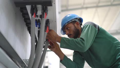 Engineer-Checking-Cables-At-Factory-Warehouse