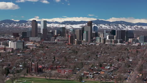 City-Park-Downtown-Denver-Colorado-aerial-drone-Spring-Mount-Blue-Sky-Evans-Front-Range-Rocky-Mountains-foothills-skyscrapers-neighborhood-streets-Ferril-Lake-daytime-sunny-clouds-circle-right-slow