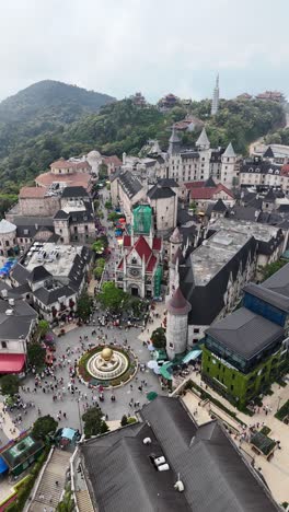 Ba-Na-Hills-Aerial-View,-Da-Nang,-Vietnam---French-Village-Replica-with-Crowds,-vertical