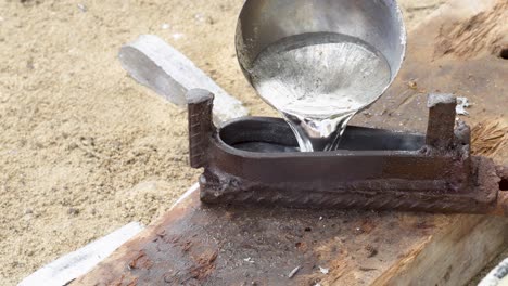 Sinker-moulding-use-ladle-for-pouring-lead,-handling-hot-molds,-work-outdoor,-close-up